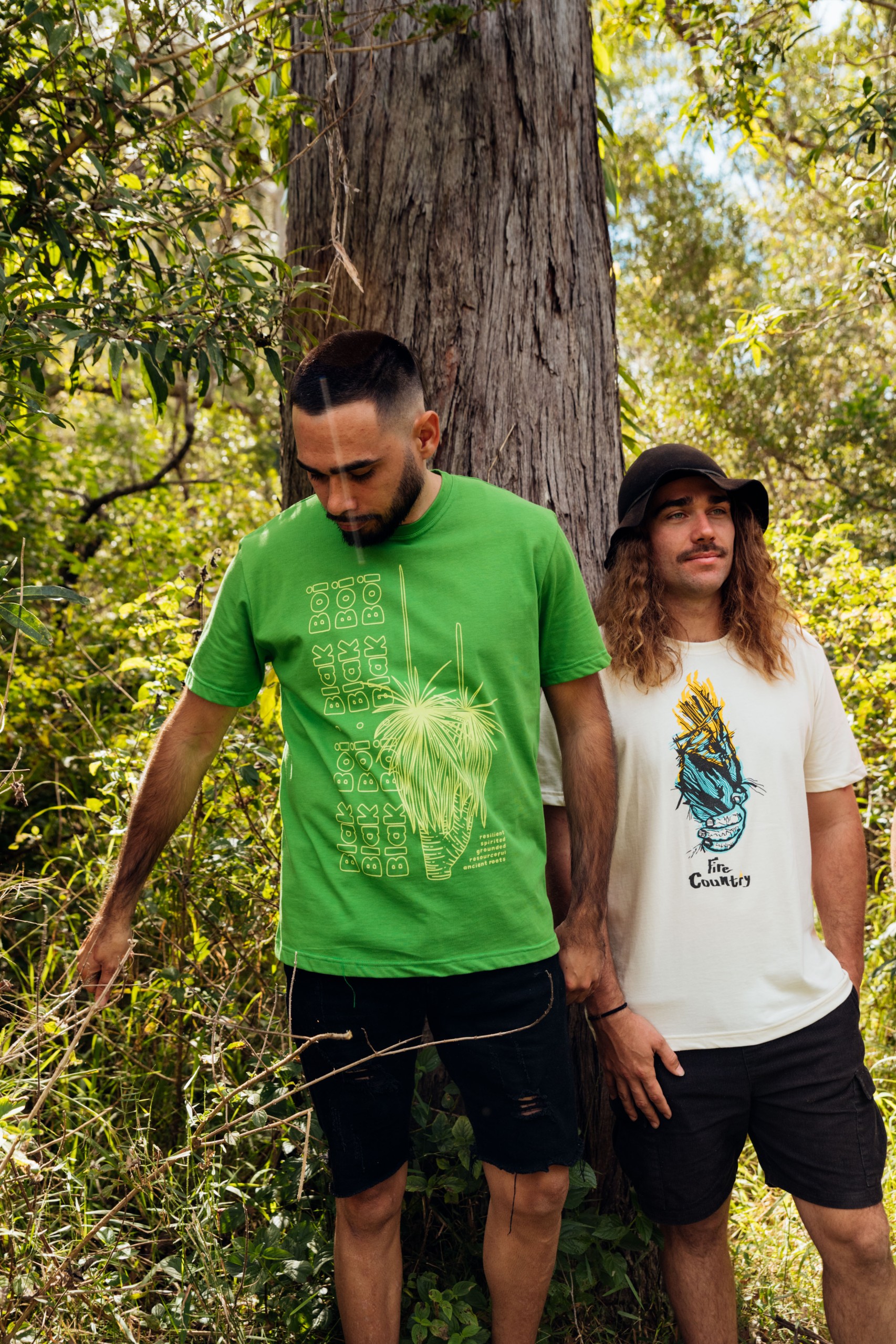 Two men stand in Firesticks x Magpie Goose Tees